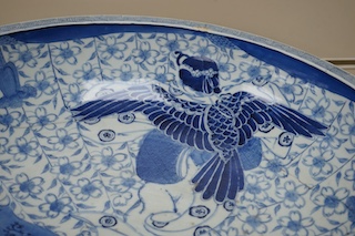 A large Japanese blue and white decorated charger, 47cm diameter. Condition - riveted and chips to rim